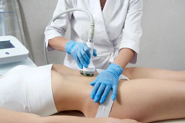 Lost the Weight but Not the Loose Skin? 2 woman having HIFU treatment on her stomach to combat loose skin Buckhurst Hill following weight loss
